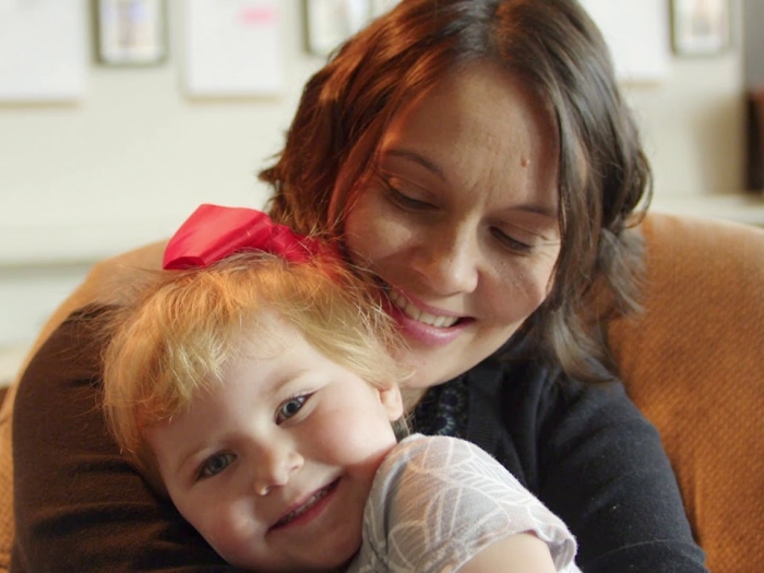 Parent and child smiling and cuddling