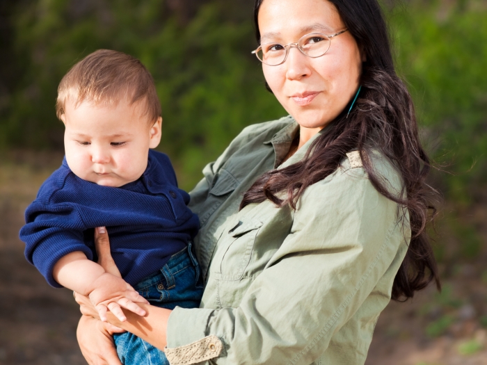 Woman holding infant outdoors